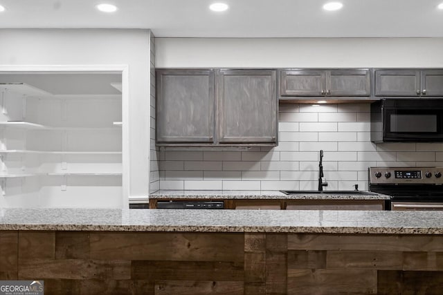 352 Grayson Trl, Hogansville, GA 30230 - kitchen featuring black microwave, electric range, light stone counters, recessed lighting, and tasteful backsplash