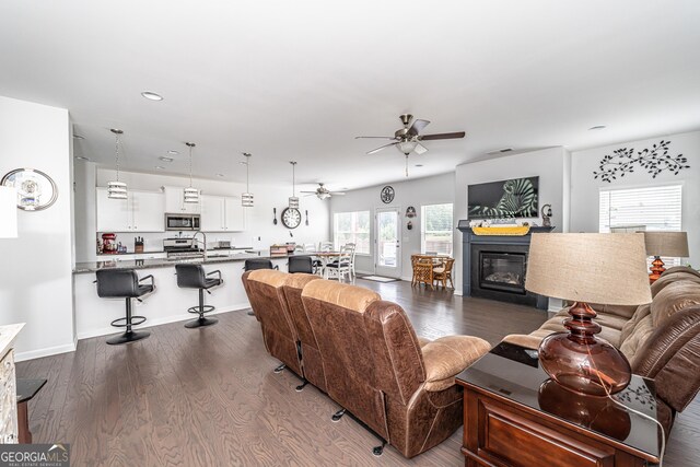 107 Topaz St, Calhoun, GA 30701 - living area with ceiling fan, dark wood-style floors, recessed lighting, and a glass covered fireplace
