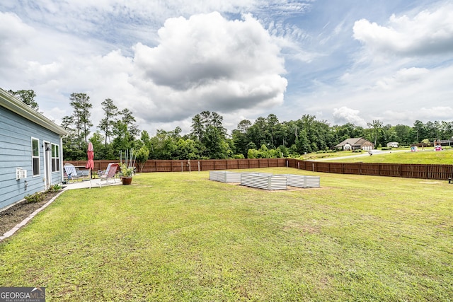 107 Topaz St, Calhoun, GA 30701 - fenced backyard featuring a patio and view of scattered trees