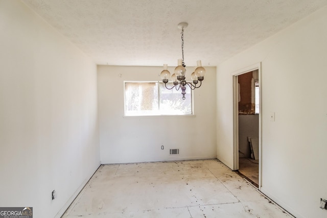 2571 Beech St, Morrow, GA 30260 - unfurnished dining area featuring a chandelier and a textured ceiling