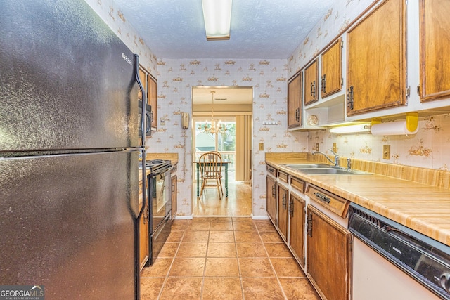 44 Twiggs Cor, Peachtree City, GA 30269 - kitchen with black appliances, wallpapered walls, brown cabinets, light countertops, and a textured ceiling