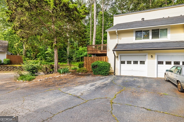 44 Twiggs Cor, Peachtree City, GA 30269 - view of home's exterior with asphalt driveway, a garage, and view of scattered trees