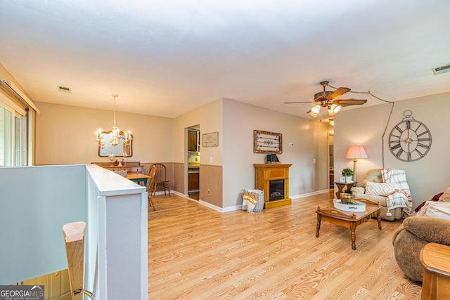 44 Twiggs Cor, Peachtree City, GA 30269 - living room with light wood-style floors, a chandelier, ceiling fan, and a fireplace