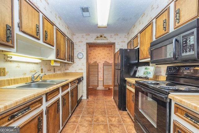 44 Twiggs Cor, Peachtree City, GA 30269 - kitchen with black appliances, wallpapered walls, brown cabinets, light countertops, and a textured ceiling