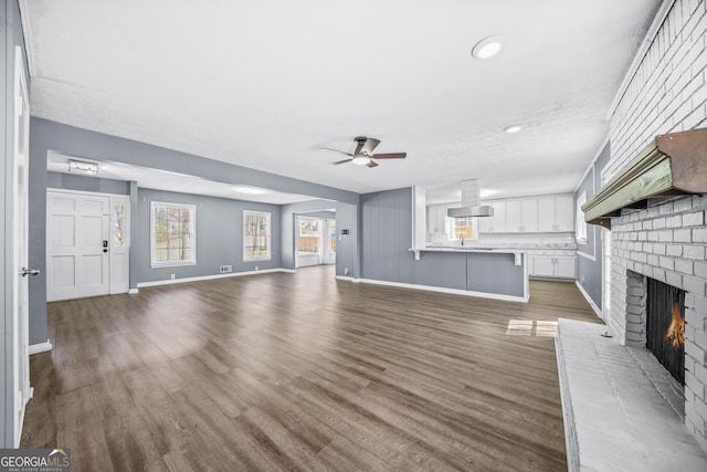 2511 Due W Cir NW, Kennesaw, GA 30152 - unfurnished living room featuring ceiling fan, a fireplace, wood finished floors, and recessed lighting