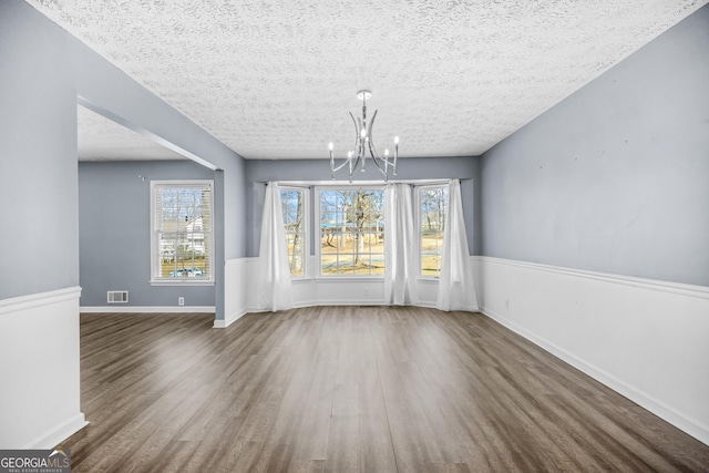 2511 Due W Cir NW, Kennesaw, GA 30152 - unfurnished dining area with a chandelier, wood finished floors, plenty of natural light, and a textured ceiling