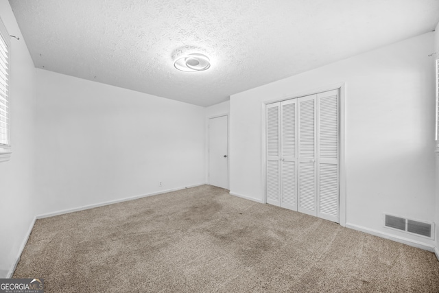 2511 Due W Cir NW, Kennesaw, GA 30152 - unfurnished bedroom featuring carpet floors, a closet, and a textured ceiling