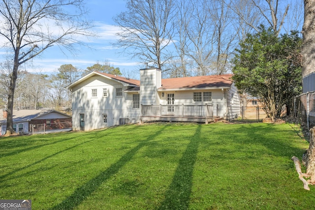 2511 Due W Cir NW, Kennesaw, GA 30152 - back of property with a chimney, a wooden deck, and a fenced backyard