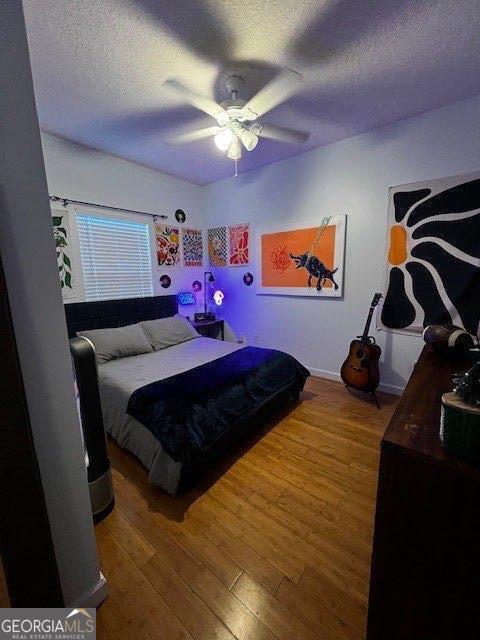 324 Moss Creek Ln, Brunswick, GA 31520 - bedroom featuring a textured ceiling, hardwood / wood-style floors, and a ceiling fan