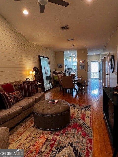 324 Moss Creek Ln, Brunswick, GA 31520 - living room with wood finished floors, ceiling fan, and wooden walls