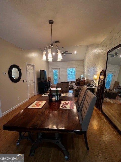 324 Moss Creek Ln, Brunswick, GA 31520 - dining room featuring wood finished floors, a chandelier, and vaulted ceiling