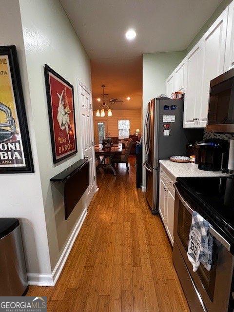 324 Moss Creek Ln, Brunswick, GA 31520 - kitchen featuring stainless steel appliances, white cabinetry, light wood-style flooring, light countertops, and recessed lighting
