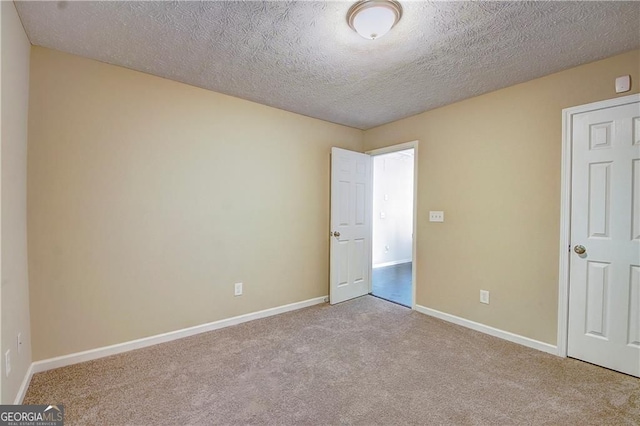 1643 Jackson Way, Atlanta, GA 30318 - unfurnished bedroom featuring carpet and a textured ceiling