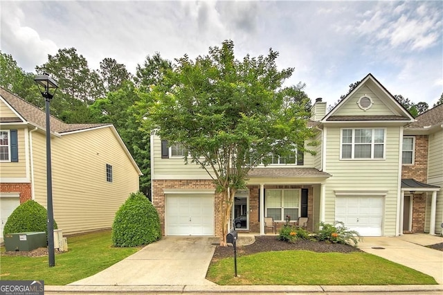 1643 Jackson Way, Atlanta, GA 30318 - traditional-style home with driveway, brick siding, a garage, and a front yard