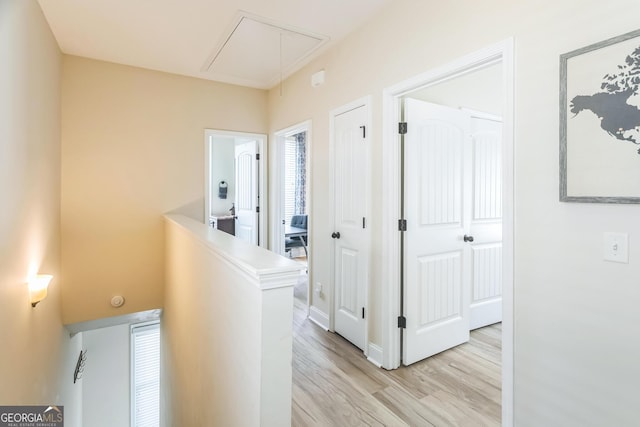 309 E 41st St, Savannah, GA 31401 - hallway with attic access, light wood-style flooring, and an upstairs landing