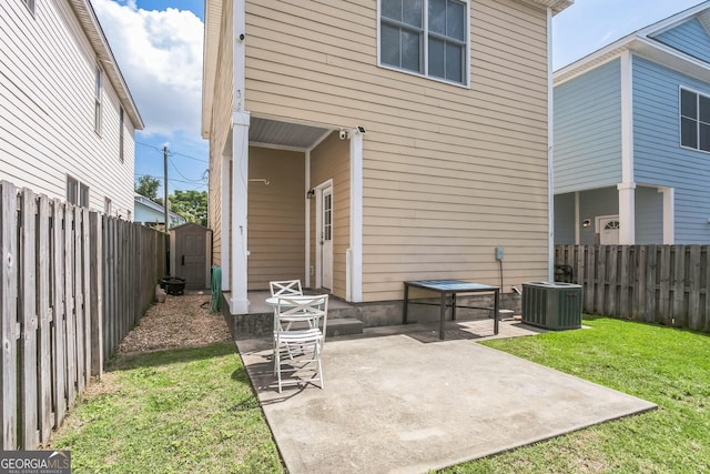 309 E 41st St, Savannah, GA 31401 - rear view of house featuring a fenced backyard, a patio area, and a storage shed