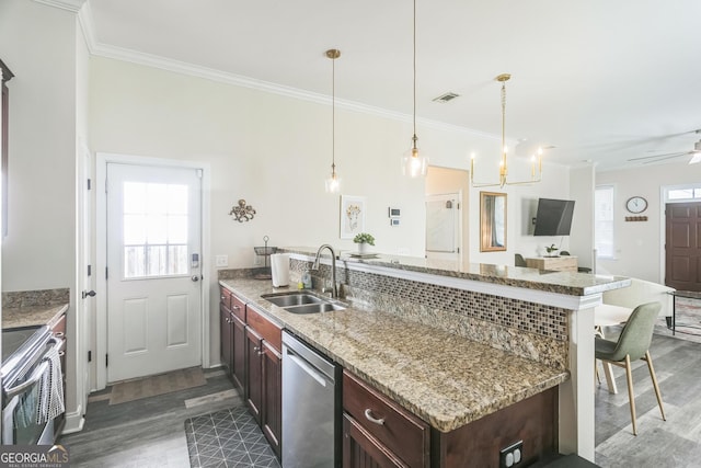 309 E 41st St, Savannah, GA 31401 - kitchen with stainless steel appliances, a peninsula, dark wood finished floors, crown molding, and a kitchen breakfast bar