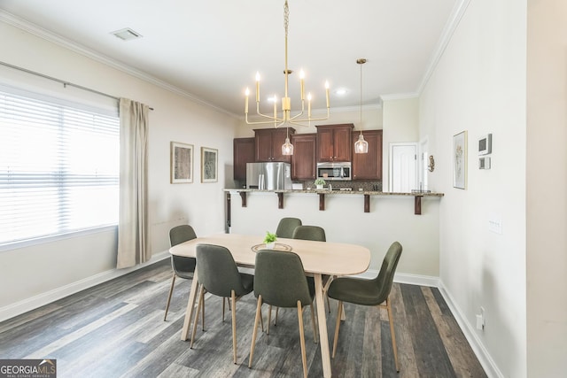 309 E 41st St, Savannah, GA 31401 - dining room featuring a chandelier, dark wood-type flooring, crown molding, and plenty of natural light