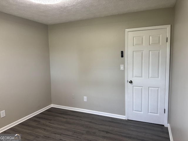 501 Carlton Rd Unit 3-D, Palmetto, GA 30268 - spare room featuring dark wood-style floors and a textured ceiling