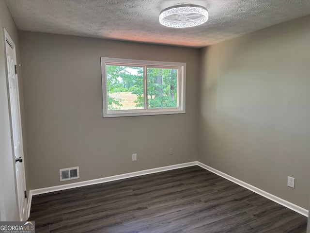 501 Carlton Rd Unit 3-D, Palmetto, GA 30268 - unfurnished room featuring a textured ceiling and dark wood-style floors