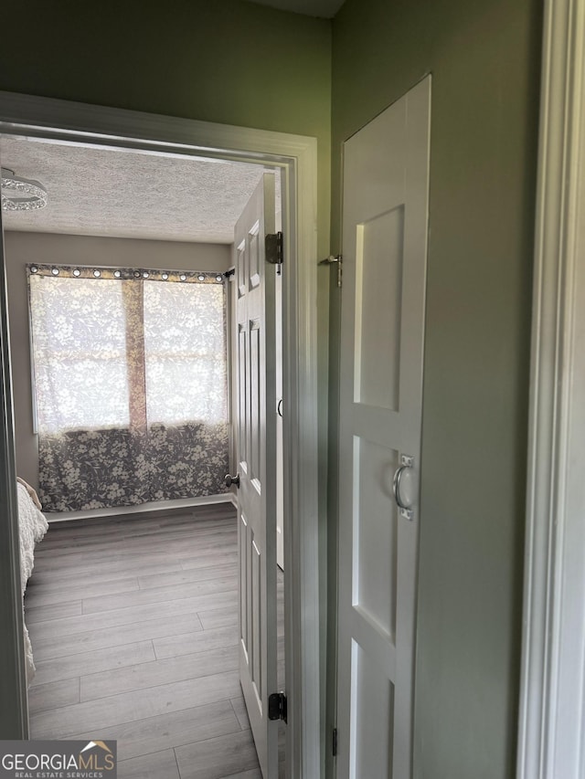 501 Carlton Rd Unit 3-D, Palmetto, GA 30268 - hall featuring wood finished floors and a textured ceiling