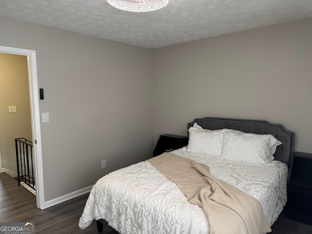 501 Carlton Rd Unit 3-D, Palmetto, GA 30268 - bedroom with dark wood-style flooring and a textured ceiling