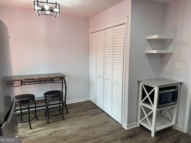 501 Carlton Rd Unit 3-D, Palmetto, GA 30268 - dining space featuring dark wood-style flooring, a textured ceiling, and arched walkways