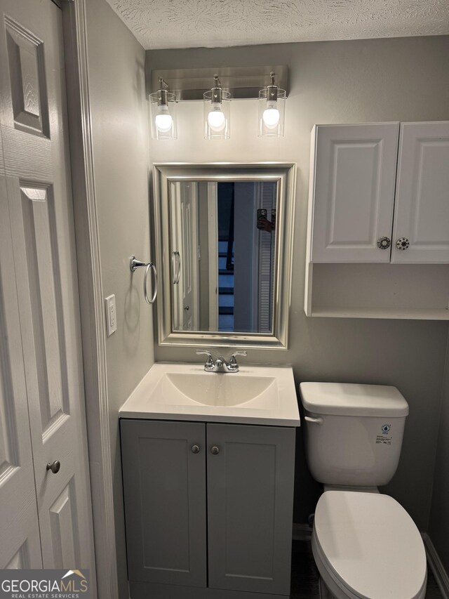 501 Carlton Rd Unit 3-D, Palmetto, GA 30268 - half bathroom with vanity and a textured ceiling