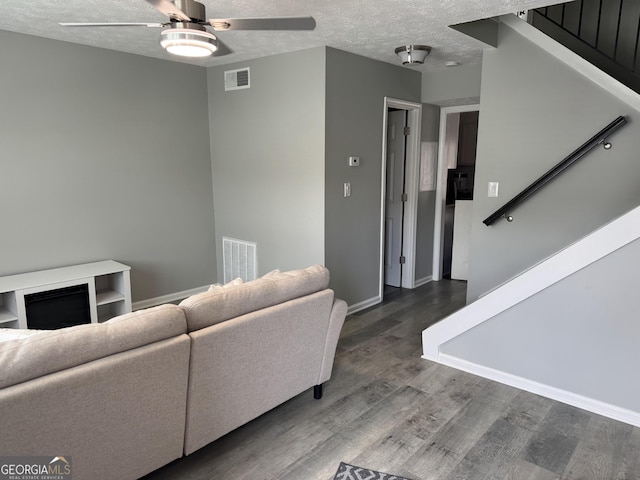 501 Carlton Rd Unit 3-D, Palmetto, GA 30268 - living area featuring ceiling fan, stairs, wood finished floors, and a textured ceiling