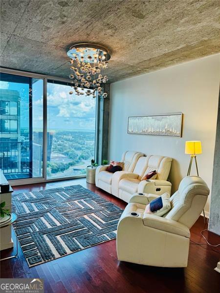 400 Peachtree St Unit 3412, Atlanta, GA 30308 - living room featuring a wall of windows, a chandelier, and wood finished floors