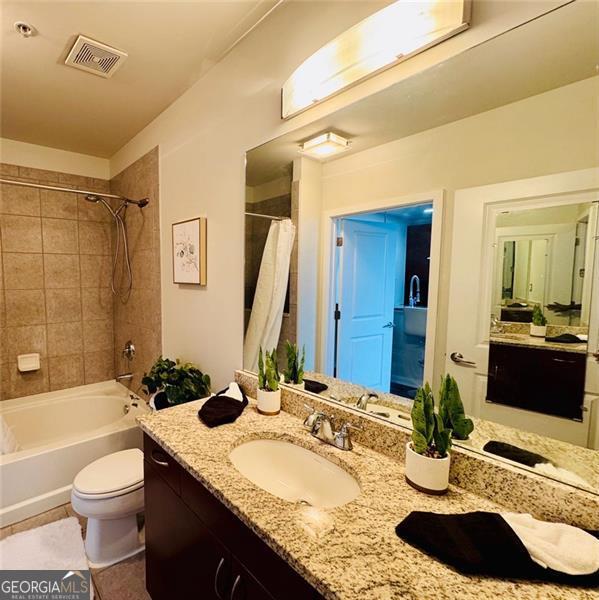 400 Peachtree St Unit 3412, Atlanta, GA 30308 - full bath featuring vanity, shower / tub combo with curtain, and tile patterned flooring