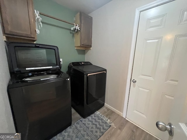 307 Pardue Dr, Thomaston, GA 30286 - washroom featuring cabinet space, separate washer and dryer, and light wood-style flooring