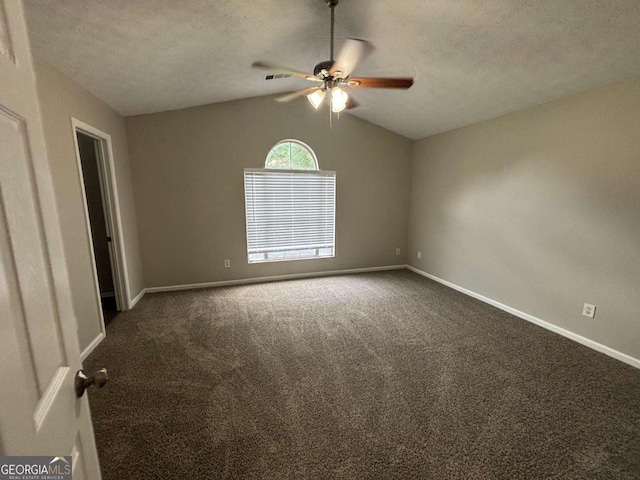 2183 Ramblewood Cir, Decatur, GA 30035 - empty room featuring a ceiling fan, vaulted ceiling, dark carpet, and a textured ceiling