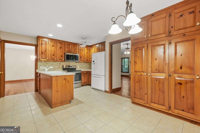 4211 Burnt Hickory Rd NW, Marietta, GA 30064 - kitchen featuring stainless steel appliances, a ceiling fan, light countertops, light tile patterned floors, and recessed lighting