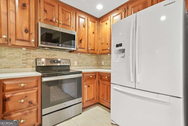 4211 Burnt Hickory Rd NW, Marietta, GA 30064 - kitchen with appliances with stainless steel finishes, light tile patterned flooring, light countertops, and brown cabinets