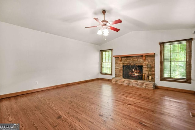 4211 Burnt Hickory Rd NW, Marietta, GA 30064 - unfurnished living room with lofted ceiling, wood finished floors, a ceiling fan, and a stone fireplace