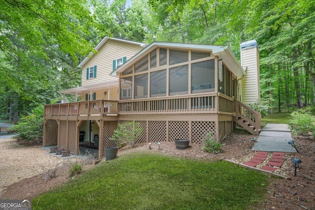 4211 Burnt Hickory Rd NW, Marietta, GA 30064 - rear view of house featuring a sunroom, a chimney, stairway, and a lawn