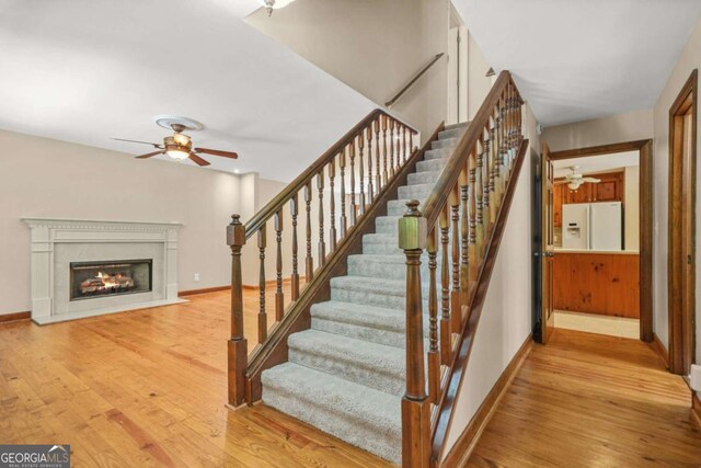 4211 Burnt Hickory Rd NW, Marietta, GA 30064 - stairs featuring ceiling fan, wood finished floors, and a glass covered fireplace