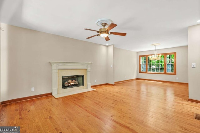 4211 Burnt Hickory Rd NW, Marietta, GA 30064 - unfurnished living room with light wood-style flooring, a ceiling fan, a fireplace with flush hearth, and a chandelier