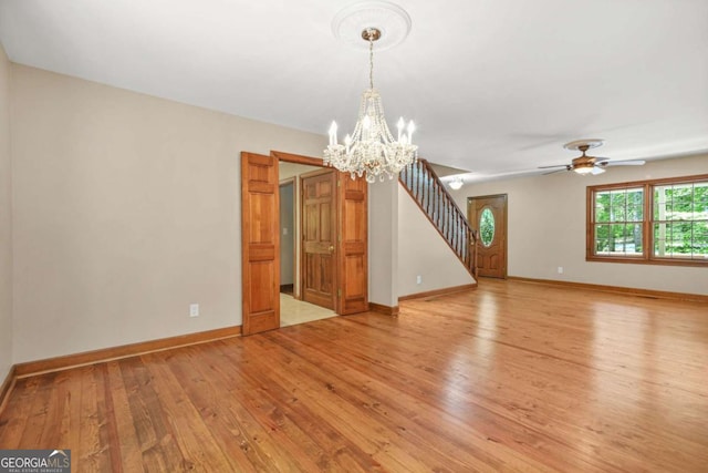 4211 Burnt Hickory Rd NW, Marietta, GA 30064 - unfurnished living room featuring light wood finished floors, a chandelier, stairs, and a ceiling fan