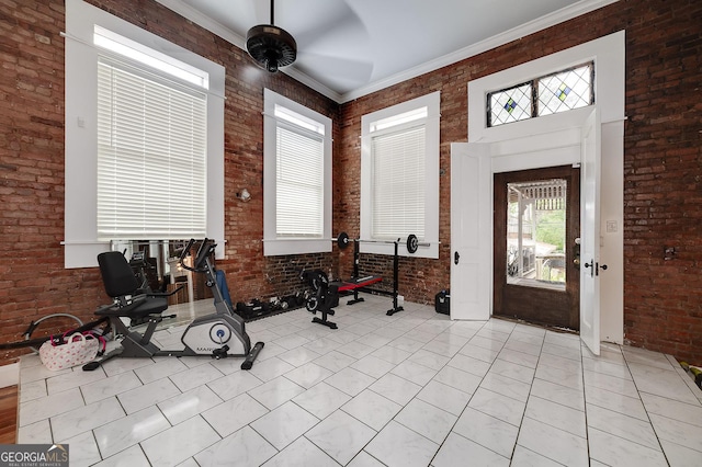 113 N Jefferson Ave, Eatonton, GA 31024 - workout room with healthy amount of natural light, brick wall, light tile patterned flooring, and ceiling fan