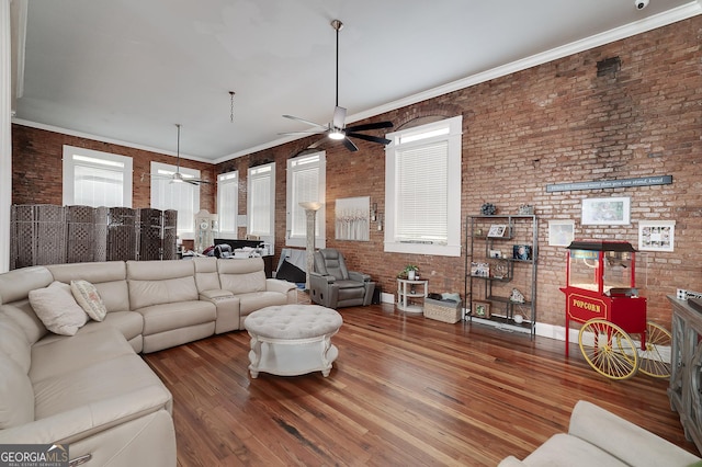 113 N Jefferson Ave, Eatonton, GA 31024 - living room featuring a ceiling fan, brick wall, hardwood / wood-style flooring, and a fireplace