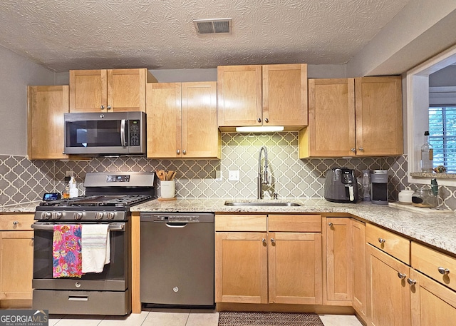 1202 Countryside Pl SE, Smyrna, GA 30080 - kitchen featuring stainless steel appliances, light stone counters, decorative backsplash, and light tile patterned floors