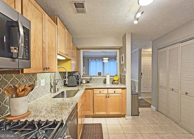 1202 Countryside Pl SE, Smyrna, GA 30080 - kitchen with stainless steel appliances, light tile patterned flooring, decorative backsplash, and light stone counters