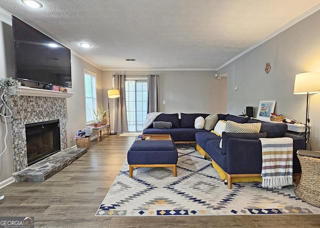 1202 Countryside Pl SE, Smyrna, GA 30080 - living area featuring a textured ceiling, ornamental molding, wood finished floors, and a fireplace with raised hearth