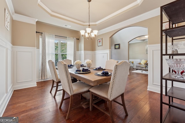 2629 Muskeg Ct SW, Atlanta, GA 30331 - dining space with a decorative wall, a raised ceiling, arched walkways, dark wood finished floors, and a chandelier
