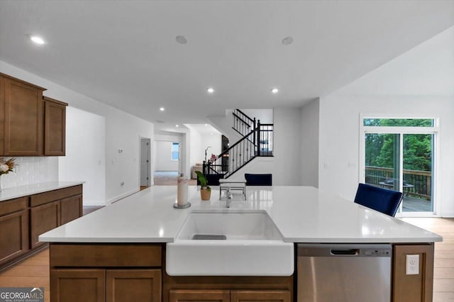 612 Michigan Cir, Hoschton, GA 30548 - kitchen with stainless steel dishwasher, open floor plan, light countertops, backsplash, and recessed lighting