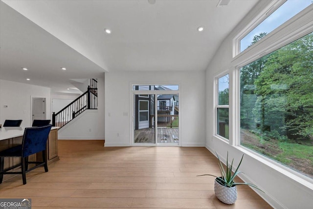 612 Michigan Cir, Hoschton, GA 30548 - unfurnished living room with light wood-type flooring, stairs, and recessed lighting