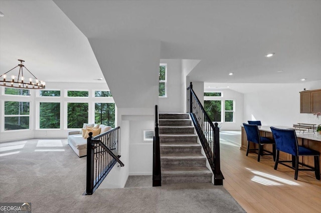 612 Michigan Cir, Hoschton, GA 30548 - stairs with recessed lighting, a chandelier, and wood finished floors