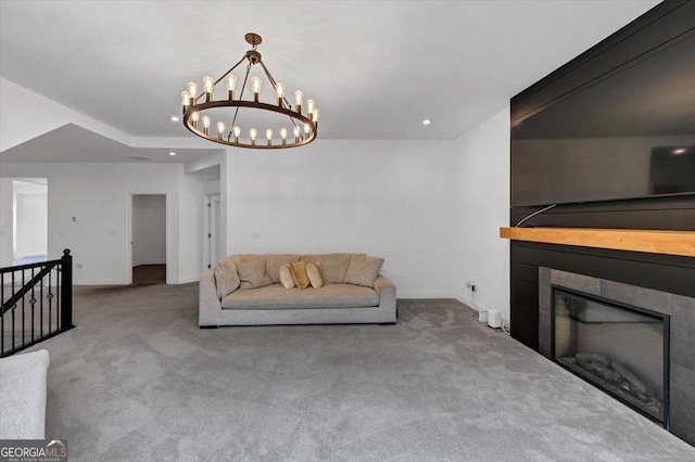 612 Michigan Cir, Hoschton, GA 30548 - carpeted living area featuring a glass covered fireplace, a chandelier, and recessed lighting